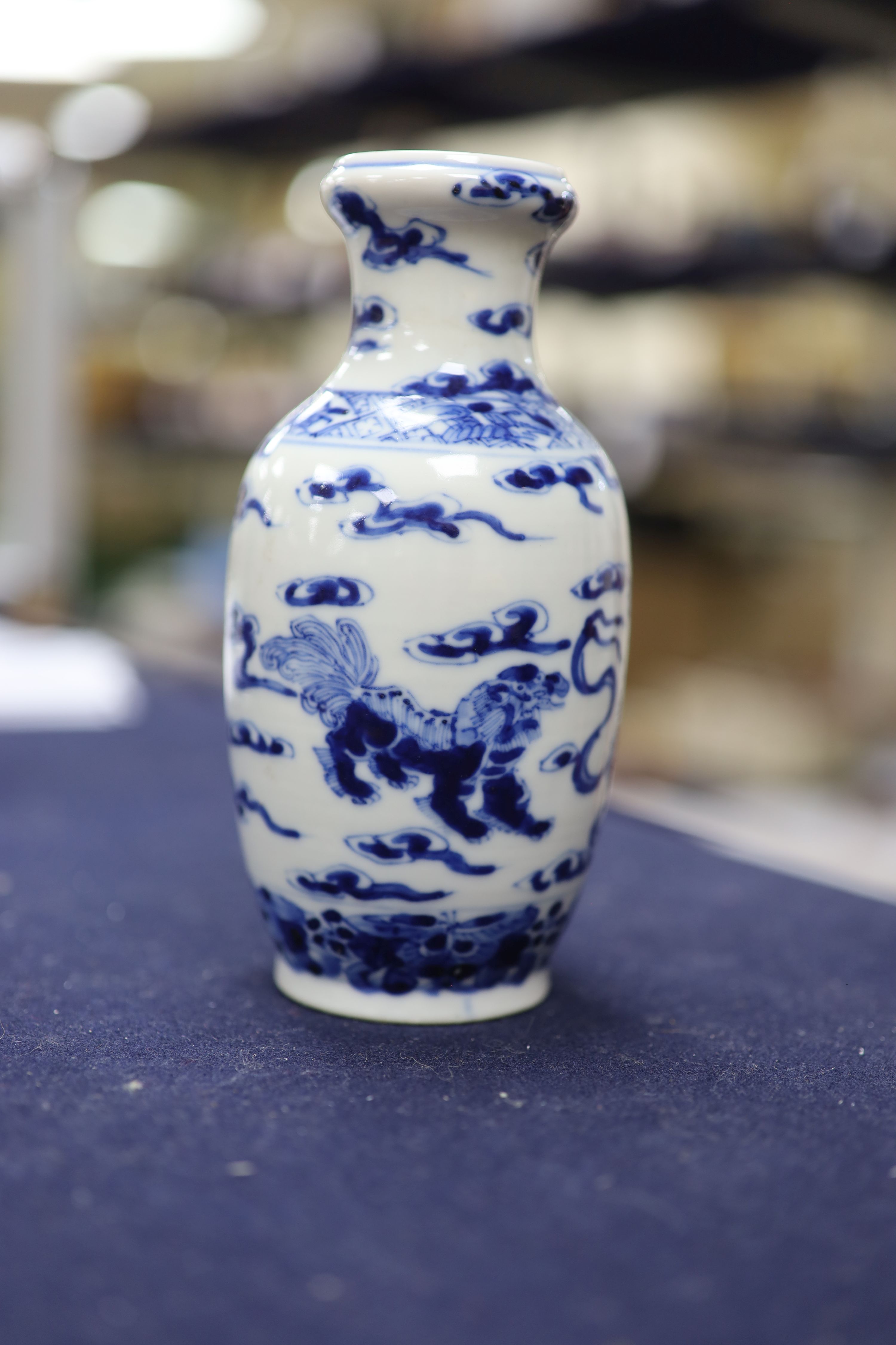 Two Chinese blue and white vases and a dish, together with a famille rose dish, tallest 28cm